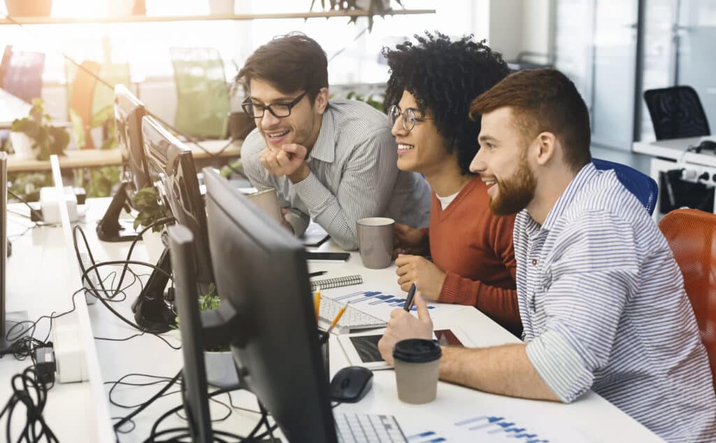 Male team of program engineers learning new skills