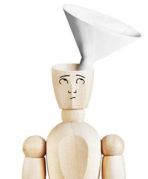 Wooden mannequin with a drawn face, head open at the top, and a large white funnel inserted into the opening.