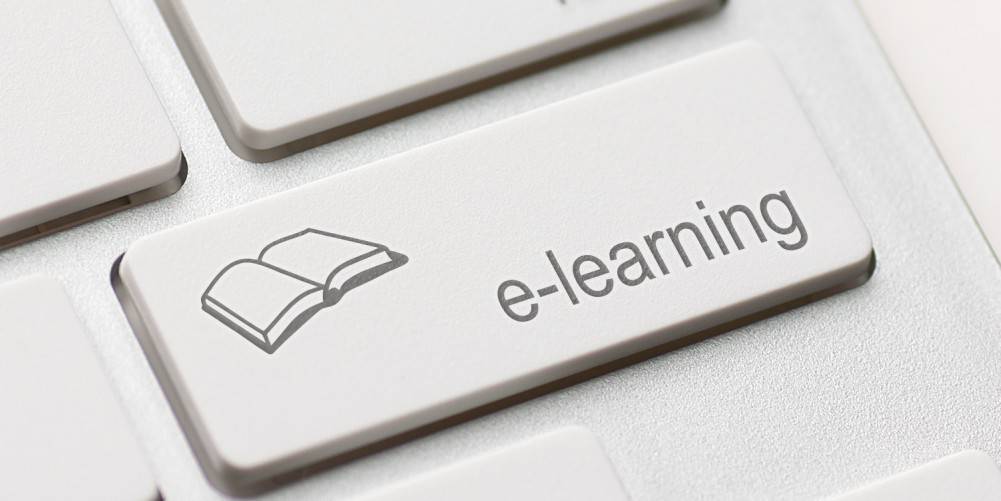 Close-up of a keyboard with a key labeled "e-learning" and an icon of an open book.
